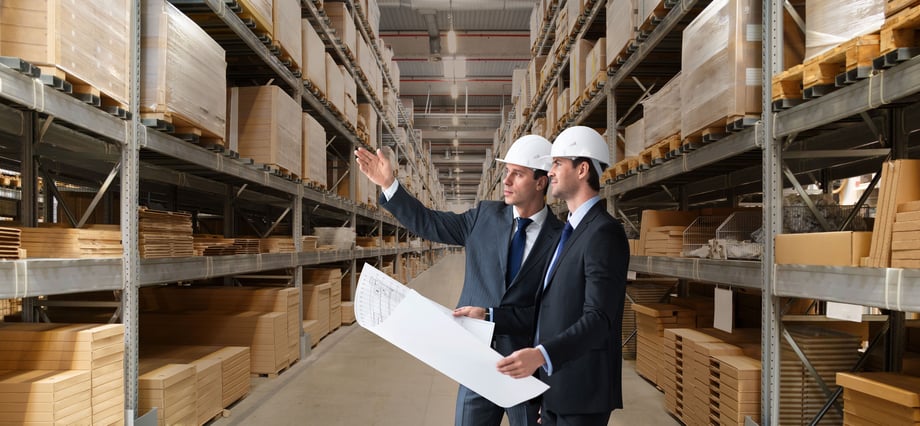 two-businessmen-in-a-warehouse-with-plans
