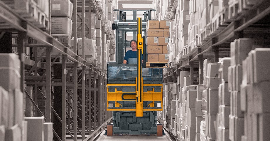 Class 2 electric forklift operating in a narrow aisle